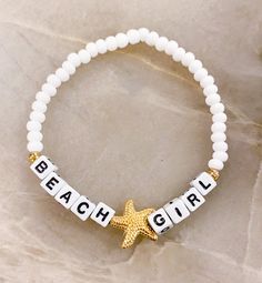 "Beach ⭐️Girl Bracelet  Sand. Salt. Sea. 18k gold filled starfish bead The perfect bracelet for the Beach Girl 🐚 Made with white 6mm seed beads, gold accents, gold starfish bead and 4mm (smaller) square letters that read \"BEACH GIRL\" If you would like another word or color, please put in Personalization Section* and we will message you if we have any questions.  CARING TIPS FOR YOUR JEWELRY ⭐️Treat and store with care. ⭐️ For longevity, avoid exposing your jewelry to water. ⭐️ Avoid having direct contact with lotions, perfumes, sanitizers as these chemicals may cause discoloration of your jewelry." Adjustable Star Bracelets For The Beach, White Star-shaped Adjustable Beaded Bracelets, Adjustable White Star-shaped Beaded Bracelets, White Letter Beads Friendship Bracelets For Beach Season, Letter Beads Bracelets For Beach Season Gifts, Adjustable White Bracelet With Starfish Charm, Starfish Charm Bracelet For Beach Season Gift, White Letter Beads Friendship Bracelets For Summer, Adjustable Strand Bracelets With Letter Beads