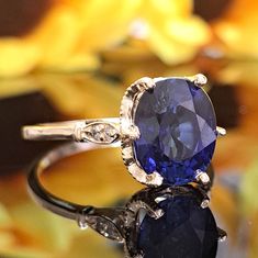 This Sapphire is authentic as they are grown in a lab environment.  One significant advantage of Chatham lab-grown gems is their minimal inclusion content compared to natural gemstones.  4.40 Carat Chatham Blue Sapphire & Diamonds 14k Solid Gold Ring Ring Material: 14k Solid Gold Ring Approximate Weight: 2.9 Grams Band Width Approximately 1.3mm Gemstone: Blue Sapphire (Lab-grown) Gemstone Color: Very Dark Blue Gemstone Clarity Grade: Eye Clean Gemstone Shape: Oval Gemstone Approximate Dimensions: 10.00x8.00mm Gemstone Quantity: 1 Gemstone Approximate Carat Weight: 4.30 Carat Diamonds: Natural Round Shaped Diamonds Color: G Diamonds Clarity Grade: Eye Clean  Diamonds Quantity: 4 Diamonds Approximate Total Carat Weight: 0.10 Carat Total Approximate Carat Weight: 4.40 Carat Ring Quantity: One Blue Sapphire Ring, Solid Gold Ring, Blue Sapphire Diamond, Natural Diamond Engagement Ring, Birthstone Gifts, September Birthstone, Blue Sapphire Rings, Engagement Anniversary, Sapphire Engagement