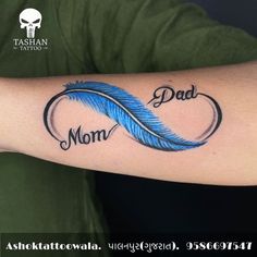 a man with a tattoo on his arm that says, mom and dad written in cursive writing