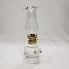 a glass vase with a gold crown on top