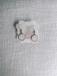 White Smiley Face Happy Smiles Earrings from Sassy Shortcake Boutique Trendy Single White Earring, Trendy White Single Earring, Playful White Dangle Jewelry, Trendy White Drop Earrings, Trendy Round Plug Earrings For Gifts, Trendy Round Plug Earrings As Gift, Trendy Dangle Plug Earrings, Nickel Free, Trendy Nickel-free Dangle Plug Earrings, Playful White Jewelry With Ear Wire