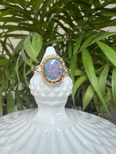 *Vintage item from 1975 *UK Size O 1/2 *Opal Triplet *9 Carat Yellow Gold  A stunning 9ct yellow gold and Opal cocktail ring. This is a striking vintage 9 Carat Yellow Gold dress ring, showcasing a gorgeous opal Triplet with a beautiful glittering display of colour, in a rubover setting with a pretty rope twist decoration.  Hallmark - This ring was hallmarked in 1975, in the UK, at the Birmingham Assay Office Stone Size -  8.8 x 6.9 mm All stones are measured by hand with a digital vernier gauge Vintage Opal Ring As A Gift, Vintage Opal Jewelry For Anniversary, Vintage Collectible Opal Gemstone Ring, Vintage Opal Rings In Yellow Gold, Vintage 14k Gold Opal Ring For Formal Occasions, Vintage Yellow Gold Opal Ring For Formal Occasions, Vintage Opal Ring Gift, Vintage Opal Ring Collectible, Vintage 14k Gold Hallmarked Opal Ring