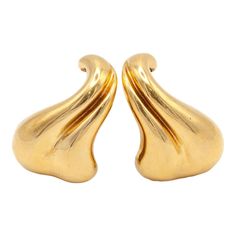 Rare Vintage MINAS SPIRIDIS Earrings. Modernist earrings are in solid 18k yellow gold, the curve design is meant to work as a hook over the intertragic notch of the ear. A very special pair of earrings indeed!  The Greek designer began designing pieces for Georg Jensen in 1992, often modern, sculptural & sleek. Minas Spiridis passed away in 2020 but his work continues to be loved.  Approximate Gross Weight: 25.40 grams  Approximate Measurement: 1.2" x 0.77" (~ 30.4mm x 19.5mm)  Hallmarks: Minas Spiridis 750, MINAS logo Contemporary Yellow Gold Hoop Earrings For Formal Occasions, Contemporary Polished Earrings For Evening, Contemporary Polished Finish Evening Earrings, Contemporary Yellow Gold Evening Earrings, Contemporary Single Earring For Formal Occasions, Contemporary Pierced Yellow Gold Earrings, Contemporary Yellow Gold Pierced Earrings, Contemporary Drop Earrings For Formal Occasions, Modern Gold Plated Clip-on Earrings For Formal Events