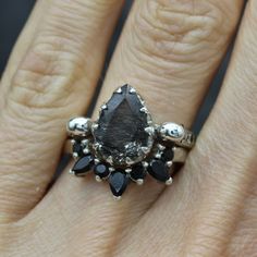 a woman's hand with a ring on it and a stone in the middle