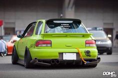 the back end of a lime green car