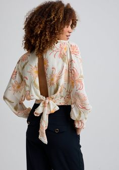 Our Maria blouse in the Moonflower print is a cut above the rest. An enchanting blouse with a bow and deep keyhole detail at the back making it effortlessly stylish. It features ruffle sleeve details adding an element of interest. The relaxed drapey fit makes it easy to tuck into your favourite pair of jeans or pair it with our Sophia Moonflower trousers.  Cool machine wash only. Wash inside out and with similar colours 100% Chiffon Viscose Sourced in India  Cool machine wash only. Wash inside out and with similar colours Chic Fitted Blouse For Garden Party, Chic Floral Print Blouse For Garden Party, Chic Floral Print Blouse For Brunch, Feminine Long Sleeve Tops For Garden Party, Spring Tie-back Blouse For Work, Spring Workwear Blouse With Tie Back, Elegant Tie Back Top For Brunch, Elegant Blouse With Tie Back For Brunch, Chic Tie Back Blouse For Spring