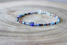 Evil Eye Bracelet/delicate Evil Eye Bracelet - Etsy Blue Spacer Beads Bracelets For Festivals, Blue Festival Bracelets With Spacer Beads, Blue Gemstone Beads Festival Bracelet, Bohemian Blue Evil Eye Bracelet For Festival, Bohemian Beaded Bracelets For Jewelry Making With Evil Eye, Bohemian Evil Eye Bracelet With Round Tiny Beads, Bohemian Evil Eye Beaded Bracelets For Jewelry Making, Bohemian Beaded Evil Eye Bracelets For Jewelry Making, Blue Beaded Spiritual Friendship Bracelets