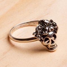 With flowers atop her skull Catrina is gorgeous. Oscar Figueroa Escorcia creates this excellent cocktail ring from gleaming Taxco sterling silver with oxidation enhancing the details. The skull tops a slender sterling band.The original La Calavera Catrina was a zinc etching created by the artist Jose Guadalupe Posada in Mexico around 1910. Posada created the character a female skeleton with an elegant hat as a satirical portrait of Mexican natives who aspired to European style and denied their o Catrina Costume Jewelry, Bohemian Sterling Silver Skull Jewelry, Adjustable Silver Skull Ring Nickel Free, Adjustable Vintage Skull Ring Gift, Adjustable Nickel-free Silver Skull Ring, Nickel-free Skull Jewelry For Day Of The Dead, Nickel Free Skull Jewelry For Day Of The Dead, Adjustable Stamped 925 Skull Ring As Gift, Adjustable 925 Stamped Skull Ring For Gift