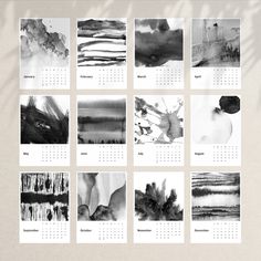 a calendar with black and white paintings on it's sides, including one in the middle