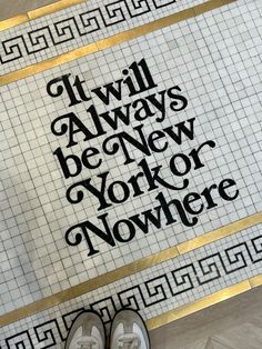 a pair of shoes sitting on top of a tiled floor next to a sign that says it will always be new york or nowhere