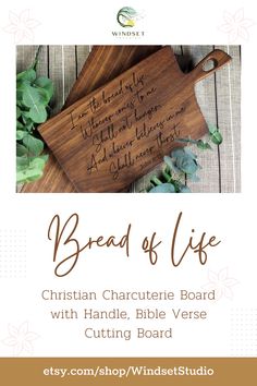 a wooden cutting board with the words bread of life written in cursive writing