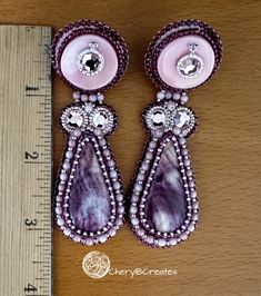 Beautiful high quality, purple spiny oyster teardrops are paired with pink conch shell tops and accented with pink crystals. Spiny oyster also can be found in red, light purple, orange and yellow. The purple variety live in deeper waters, making them extra difficult to find and harvest and why they are more expensive. These earrings close with a large leverback made from gold finished brass and measure 3 inches long. These spiny oyster earrings will look fabulous with jeans as well as your dressier outfits. Unique Pink Teardrop Jewelry, Pink Teardrop Earrings With Natural Stones, Unique Pink Teardrop Earrings, Oyster Earrings, Embroidery Earrings, Shell Tops, Expressive Art, Spiny Oyster, Conch Shell