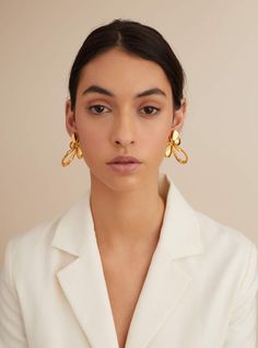 Editor's Note Design-driven yet emotionally rooted, the OH Poppi Tuberose Stud earrings find their essence from the delicate beauty of the iconic 5-petal monogram. The OH Poppi Tuberose studs flow into exaggerated lines that are larger than life and celebrate the unbridled liveliness and joie de vivre of the monogram in this 22kt gold rendition. The beauty of the earrings is emblematic only by the conquering yet the graceful spirit of its wearer. Celebrate the brilliance of the style with the OH Chic Gold Earrings For Workwear, Chic Gold Earrings For Work, Luxury Earrings For Workwear, Elegant Gold Earrings For Workwear, Elegant Gold Earrings For Work, Personal Shopping Service, Charms Necklace, Larger Than Life, Delicate Beauty