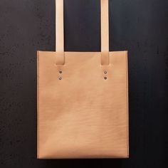 "Minimal Handmade Italian Leather Tote bag , Minimal purse , woman bag , Full grain Italian leather shoulder bag . Natural leather tote bag (2.2mm) entirely hand-sewn with long handles. Why Hand Stitching? Leather sewing machines commonly use the \"lock stitch\" , If just one loop of a lock stitch is broken, the other side will automatically be loosened, often this process of unraveling will continue until the entire product is ruined. for hand stitched leather product, it will not unravel if on Minimalist Satchel Bag With Leather Lining, Everyday Smooth Grain Shoulder Bag, Minimalist Rectangular Shoulder Bag With Leather Lining, Minimalist Leather Pouch Bag, Minimalist Smooth Grain Crossbody Bag, Natural Box Bag With Adjustable Strap For Everyday Use, Beige Rectangular Bag With Leather Lining, Minimalist Leather-lined Satchel Shoulder Bag, Minimalist Satchel Shoulder Bag With Leather Lining