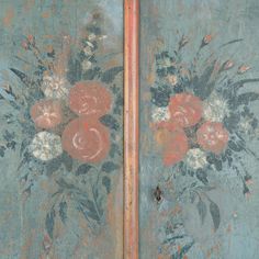 two painted doors with flowers and leaves on them