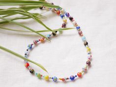 This millefiori beaded necklace is so colorful and cute. In this silver- or gold plated necklace, I have paired colorful millefiori glass beads with tiny glass seed beads. The beading wire I use is high-quality stainless steel, composed of multiple twisted tiny wires that are nylon coated to protect the beads. This necklace adds color to any outfit and is both laid-back and cool at the same time. The length of the necklace is 15 inches (38 cm), with a 2 inches (5 cm) extension chain - so you can adjust the length of your necklace between 15 inches and 17 inches (38 - 43 cm).  Want a matching bracelet? You can find it here: https://www.etsy.com/fi-en/listing/1276236567/millefiori-glass-beads-bracelet-colorful Or same design with some pearls: https://www.etsy.com/fi-en/listing/1281848075/mil Colorful Beads As A Gift, Festival Multicolor Glass Necklaces, Festival Multicolor Glass Necklace, Multicolor Single Strand Bead Choker, Multicolor Glass Necklaces For Festivals, Multicolor Small Glass Beads, Multicolor Polished Beads Choker, Multicolor Polished Beads Choker Jewelry, Multicolor Polished Bead Choker