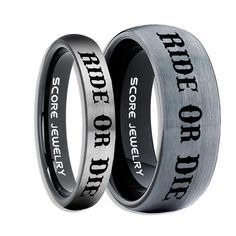 two wedding rings with words engraved on them, one is black and the other is silver