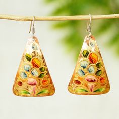 Recalling the pyramids at Tzuntzuntzan Rosy and Daniel give a triangular shape to these delightful earrings. They're crafted from copper and hand-painted with delicate floral designs in gold orange moss green and lilac. Ad Earrings, The Pyramids, Gold Orange, Orange Gold, Moss Green, Floral Designs, Hook Earrings, Floral Painting, Pyramid