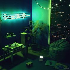 a room with a neon sign on the wall next to a table and chair in front of it