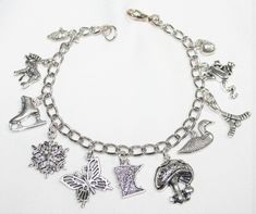 "This adorable charm bracelet is handcrafted using Rhodium Finished Nickel Free Cable Chain, 11 nickle free zinc alloy charms, Corn Charm, Moose Charm, Ics Skate Charm, Snowflake Charm, Butterfly Charm, Mushroom Charm, Minnesota State Charm, Duck Charm, Hockey Sticks Charm, Frog Charm, Apple Charm, Lobster Clasp This bracelet measures approx 7 - 1/2 \" in length. You have the option to choose other bracelets sizes and also to add an initial charm When purchasing a bracelet for someone other than Symbolic Metal Charm Bracelet With Dangling Charms, Novelty Silver Charm Bracelet Gift, Novelty Silver Metal Charm Bracelet, Silver Novelty Charm Bracelet As A Gift, Silver Novelty Charm Bracelet Gift, Nickel-free Themed Charm Bracelet As Gift, Silver Novelty Charm Bracelet, Silver Novelty Metal Charm Bracelet, Silver Novelty Bracelets With Charms