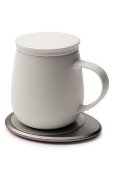 a white coffee cup sitting on top of a saucer with a silver plate underneath it