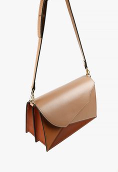 Beautifully handcrafted structured shoulder handbag with a fold-over flap and inside-flap magnetic closure. The Angle Patch beige structured handbag has an unusual geometric design and an adjustable shoulder strap. The two gussets are unique and functional with two interior compartments. One interior credit card pocket. Adjustable shoulder strap length 43 inches long. Handbag measures approx. 8.5 x 3.5 x 5.5 inches. A classic elegant handbag in warm beige, tan, and brick orange leather. The perf Modern Rectangular Saddle Bag With Detachable Strap, Modern Rectangular Saddle Bag With Detachable Handle, Modern Rectangular Saddle Bag For Evening, Modern Rectangular Saddle Bag For Evenings, Modern Beige Flap Bag With Adjustable Strap, Modern Beige Flap Bag With Removable Pouch, Modern Satchel Saddle Bag With Magnetic Closure, Modern Beige Flap Bag For Business, Modern Beige Saddle Bag