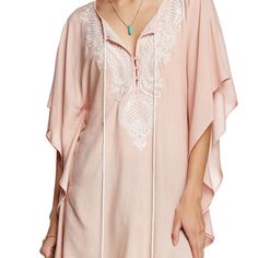 Women's Top Features Embroidery Detail. Flowy Sleeves With Side Seams And Tie Neck Closure. Back Features Embroidery Detail At Base Of Neck.