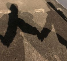 the shadow of a person holding a skateboard