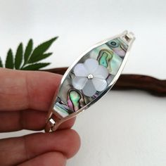 This charming Mother of Pearl and Abalone shell bracelet was handcrafted in Mexico. Each piece of shell was cut and polished by hand, an intricate piece of shell inlay work of mother of pearl flower segments and an abalone background. This bracelet is silver plated. This is part of a collection of jewellery that I make with Mexican artisans. Inspired by my mum's collection from the 80's when she bought and sold Mexican jewellery on her London market stall. I still have some of her vintage pieces Abalone Shell Bracelet, Bracelet Mexican, Abalone Bracelet, London Market, Floral Cuff, Market Stall, Mexican Jewelry, Shell Bracelet, Woodland Wedding