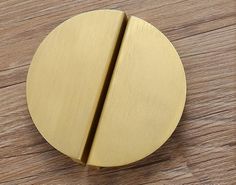 a close up of a wooden surface with a metal object on it's side