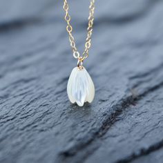 Beautiful hand carved Mother of Pearl Pikake bead necklace. These Pikake are not plastic, they are real carved mother of pearl. This Pikake necklace is so dainty and pretty to look at! Check out the matching earrings here: https://www.etsy.com/listing/1028920579/single-pikake-mother-of-pearl-earring Your choice of sterling silver or gold fill - they will not tarnish and can even get wet. Each Pikake is hand carved and may vary slightly one from the next in size and details. Dainty White Drop Necklace For Gifts, Delicate White Drop Necklace For Gift, White Dainty Shell Necklace As A Gift, Delicate Handmade White Charm Necklaces, Handmade White Briolette Necklace, Dainty White Shell Necklace For Gifting, Dainty White Shell Necklace For Gift, Handmade Flower Shell Necklace Gift, Delicate White Briolette Necklace