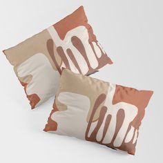 two brown and white pillows sitting on top of each other