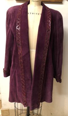 "Trimmed in criss-crossed strips of purple python , shoulder pads, lined in quilted rayon, this swing coat is an extra large Cuffs: 3\" Deep Bust: 42\"-46\" Sleeve: 25\" Center back: 35\" Because of the swing Style And the open front, this is a free Size  She has welt pockets and a chain for hanging" Purple Coat, Vogue Spain, Purple Suede, The Swing, Crepe Dress, Historical Clothing, Long Coat, Welt Pockets, Python