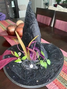 a witches hat sitting on top of a table next to other decorations and decorating items