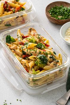 three plastic containers filled with food on top of a white table next to bowls of rice and vegetables