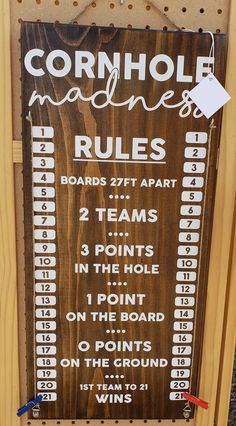 a sign that is on the side of a wooden board with numbers and words written in white