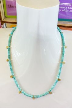 Delicate and dreamy, this Daisy Aqua Necklace is the perfect balance of sweet and chic. Small pearl beads are strung together with tiny gold daisy charms that add a playful touch of charm to your neckline. Whether you're pairing it with a sundress for brunch or layering it with other necklaces for a casual day out, this dainty piece brings a little sunshine to any outfit. Ocean-inspired Necklaces With Pearl Charm For Beach, Ocean-inspired Pearl Charm Necklaces For Beach, Green Beach Necklace With Faceted Beads, Ocean-inspired Charm Necklace For Summer Beach, Turquoise Ocean-inspired Necklace With Starfish Charm, Aqua Necklace, Swimsuit Jewelry, Daisy Charm, Drinking Accessories