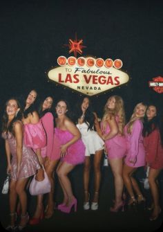 the girls are posing in front of the las vegas sign