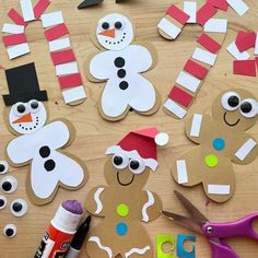 paper cut out to look like snowmen and gingerbreads on a wooden table