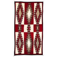 a red and white rug with geometric designs