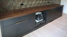 a kitchen counter with an appliance in the center and a wallpaper behind it