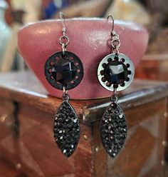 I love old buttons and have collected them for years.  These beautiful black Victorian buttons were the perfect pair to create earrings.  I added vintage black encrusted rhinestone drops and sterling earwires.  They came out beautifully!  Measurements from the top of the earwire to the bottom of the drop are 2-1/2" and the drop is 1-7/8". I love working with antique and vintage parts and do my best to describe and show them in photo's. Please let me know if you have any questions. Thanks for visiting my shop! - Debbie Black Earrings With Rhinestones For Gift, Gift Black Earrings With Rhinestones, Vintage Black Pierced Earrings, Black Vintage Pierced Earrings, Vintage Black Dangle Earrings, Vintage Black Metal Earrings, Black Vintage Metal Earrings, Vintage Black Drop Earrings, Victorian Buttons