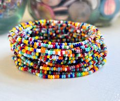 These dainty bracelet sets are perfect for layering, offering a fun and colorful addition to your boho jewelry collection with their stackable, stretchable design.*  Purchase multiples and save *  Made from tiny glass seed beads (2mm)  *  Available in multiple sizes *  Strung on durable beading elastic. *  Shipped to you in our recyclable packaging 🦋YOU MAY ALSO LIKE Daisy & Dahlia Bracelets https://etsy.me/4855PlF Seed Bead Bracelets https://bit.ly/stonesandpaper Tila Bracelets- https://etsy.me/3phAFHw  🦋DON'T SEE YOUR SIZE LISTED? The sizes we have listed are what we keep on hand to ship as quickly as possible We are happy to make a custom size.  Simply drop us a note to request a custom size Custom size requests are fulfilled based on supply availability 🦋 FIND THE PERFECT FIT * Meas Bohemian Multicolor Wrap Bracelet With Tiny Beads, Rainbow Tiny Beads Bracelets For Festival, Multicolor Tiny Beads Wrap Bracelet, Multicolor Tiny Beads Wrap Bracelet For Friendship, Multicolor Stackable Stretch Bracelet For Beach, Bohemian Rainbow Bracelets With Tiny Beads, Multicolor Tiny Beads Wrap Bracelet For Beach, Bohemian Multicolor Stackable Friendship Bracelets, Multicolor Tiny Beads Stretch Bracelet For Friendship