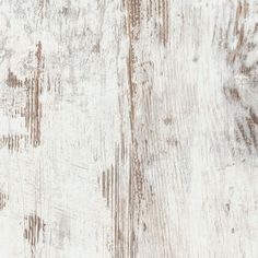 an old white wooden surface with peeling paint and chipped wood grains on it