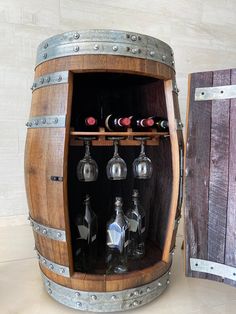 a wooden barrel with wine glasses and bottles in it