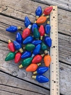 colorful christmas lights on wooden table next to ruler