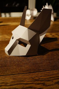 an origami bull head sitting on top of a wooden table