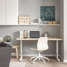 a white chair sitting in front of a desk