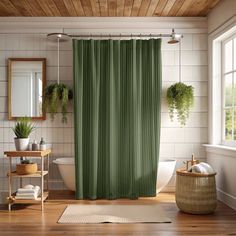 a green shower curtain in a bathroom with wood floors and white tile walls, potted plants on the window sill