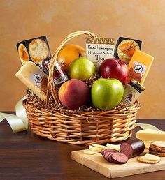 a basket filled with fruit and crackers on top of a table